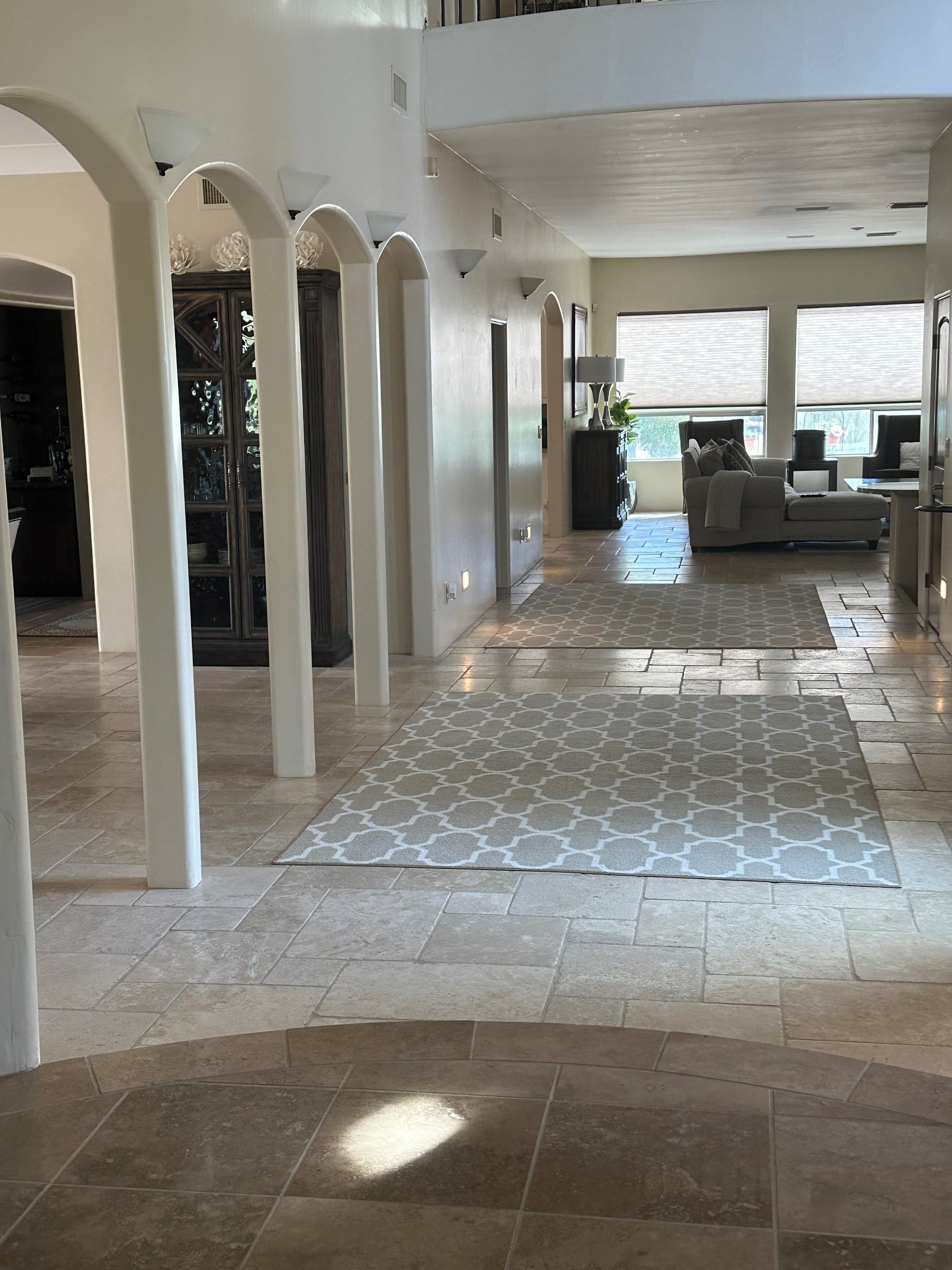 a large hallway with columns and a rug on the floor | Litchfield Park, AZ | Cleaning Elite