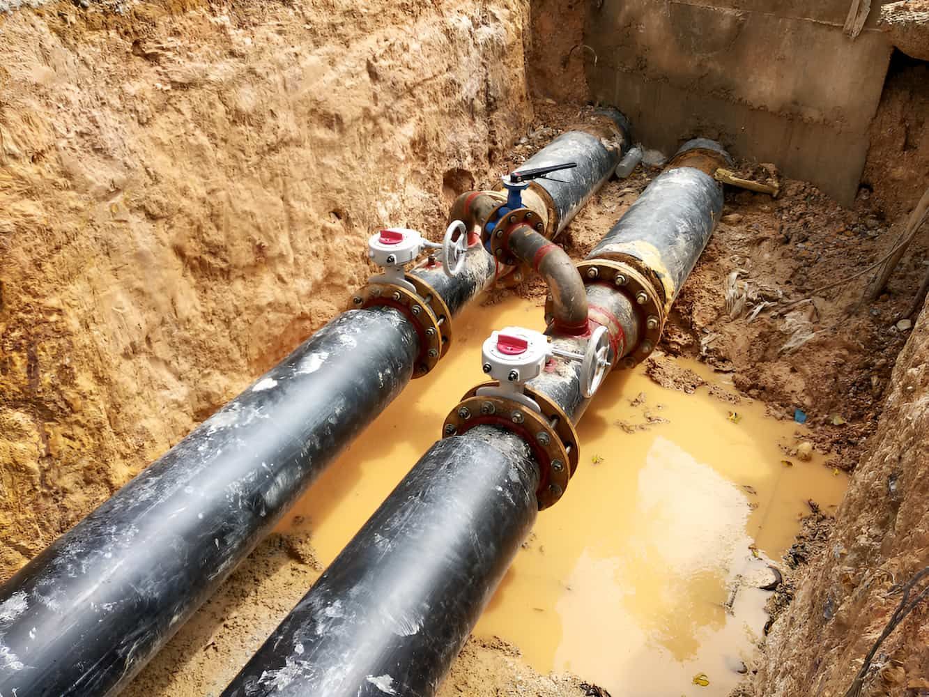 Two Black Pipes Are Connected To Each Other  Underground — CQ Service Locating In Mackay, QLD