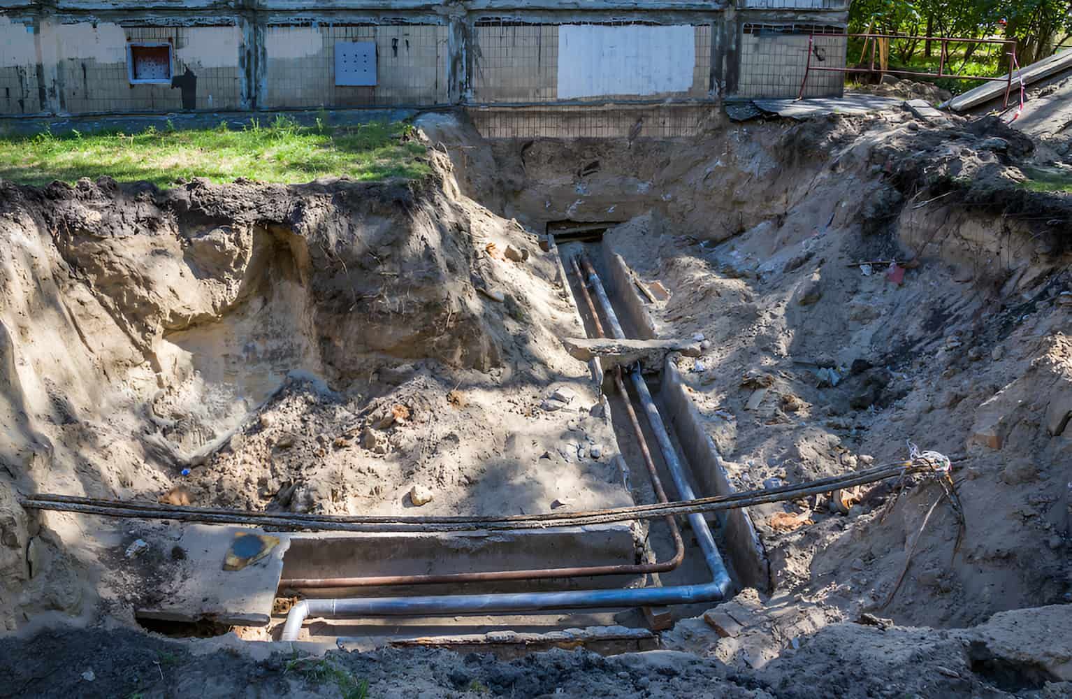 A Large Hole In The Ground With Pipes — CQ Service Locating In Gladstone, QLD
