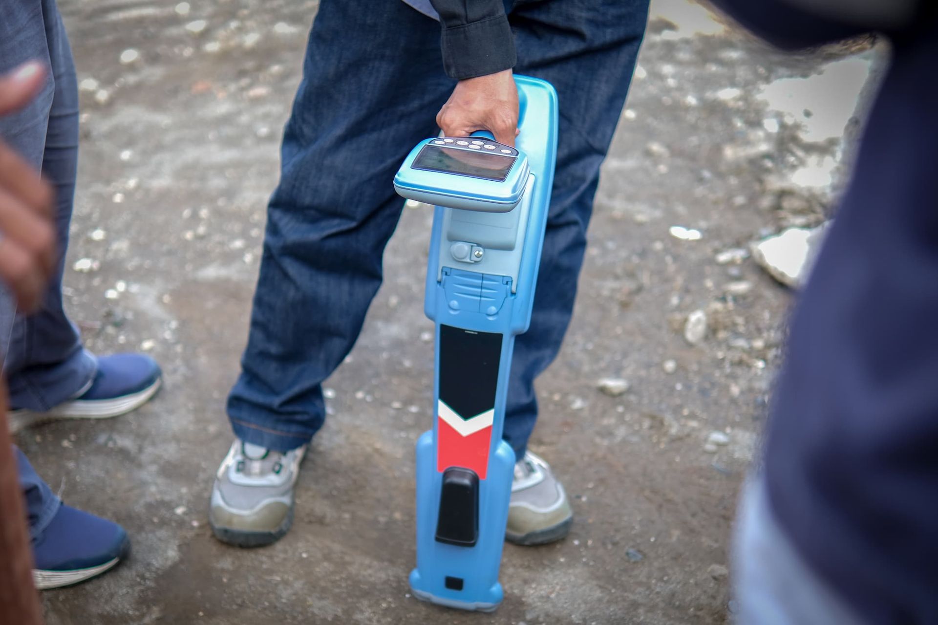 A Man Is Holding A Cable And Pipe Locator — CQ Service Locating In Biloela, QLD