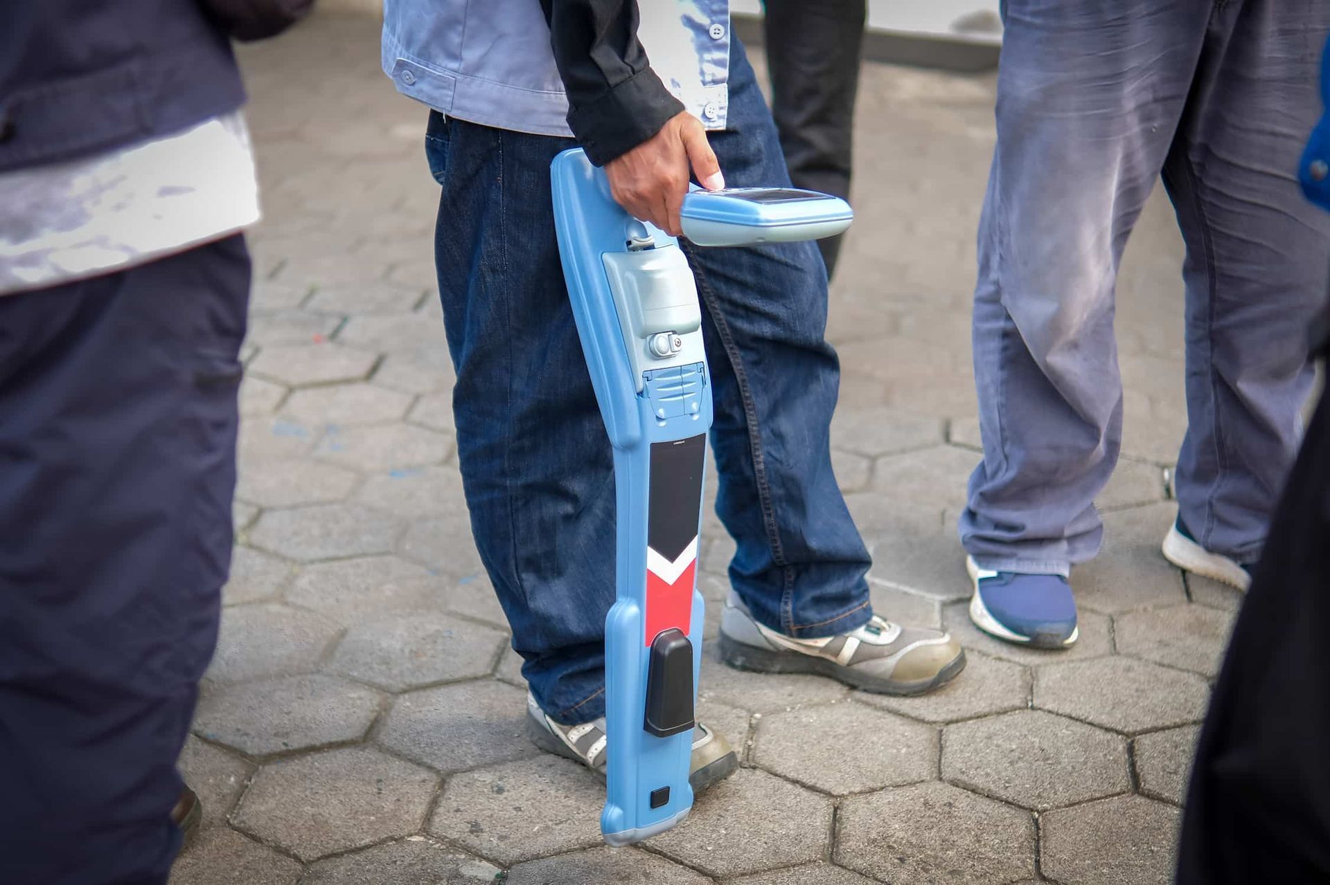 A Man Is Holding A Cable And Pipe Detector Device — CQ Service Locating In Mackay, QLD