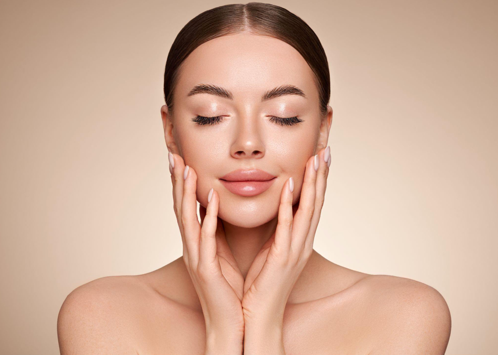 Three people in a hallway: a man in scrubs, a young man, and a woman in scrubs, smiling.
