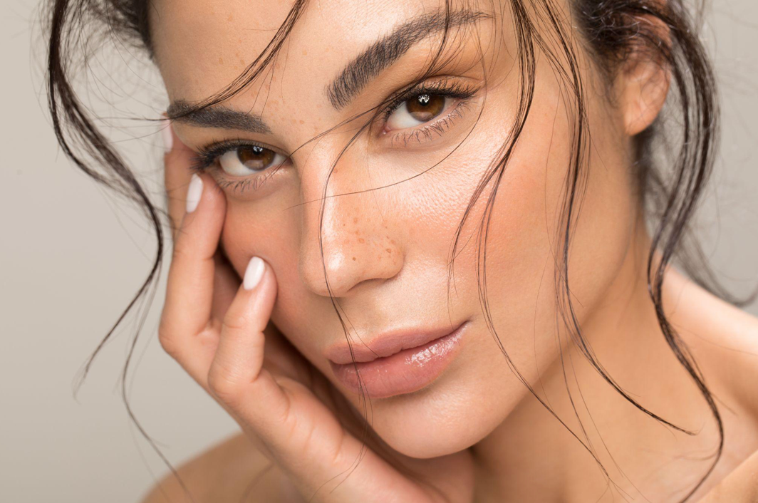 Advertisement for Bellafill filler, featuring a smiling woman, promoting long-lasting, natural results.