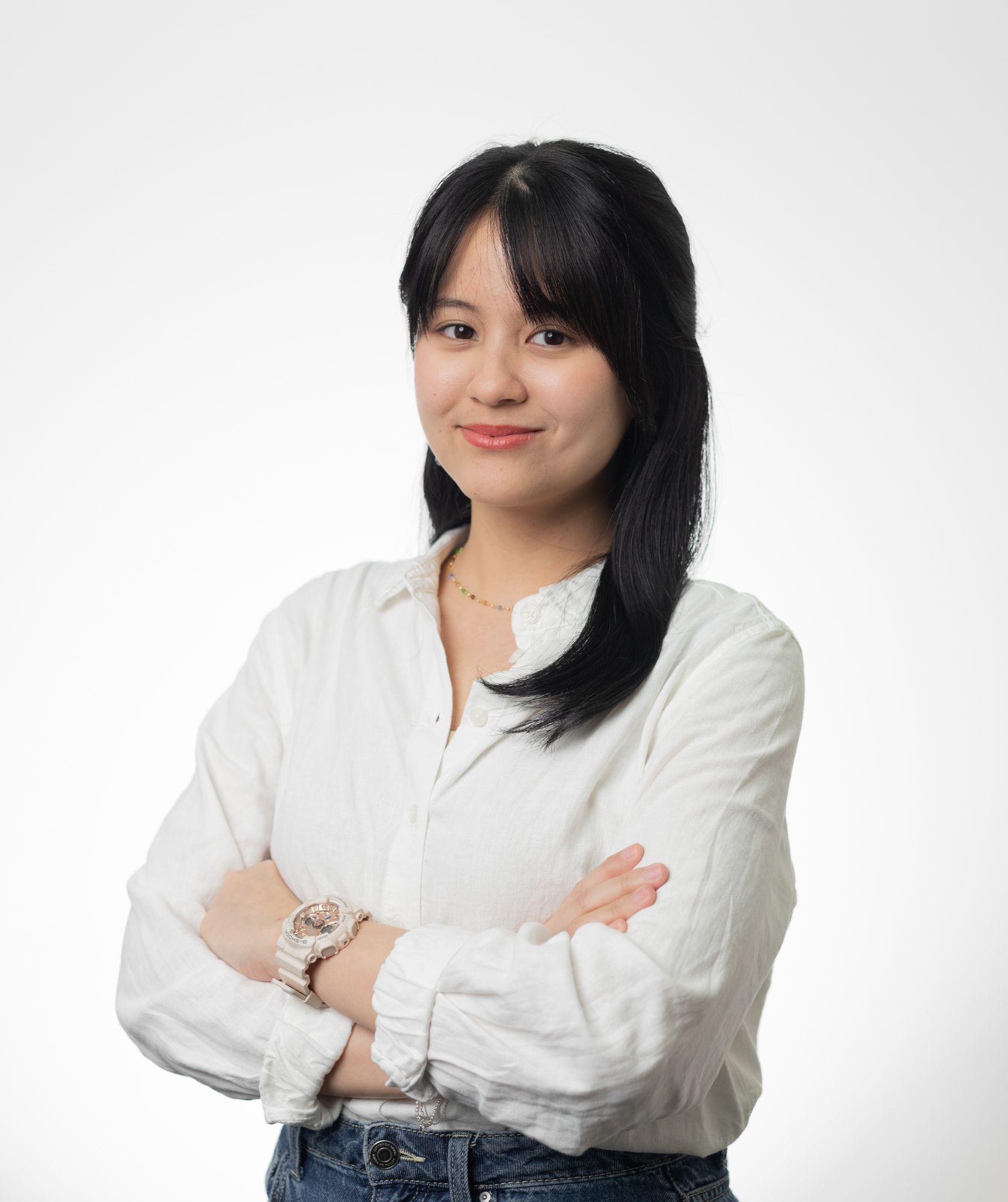 A young woman is standing in front of a colorful graffiti wall.