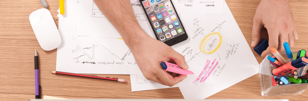 A person is writing on a piece of paper with a marker.