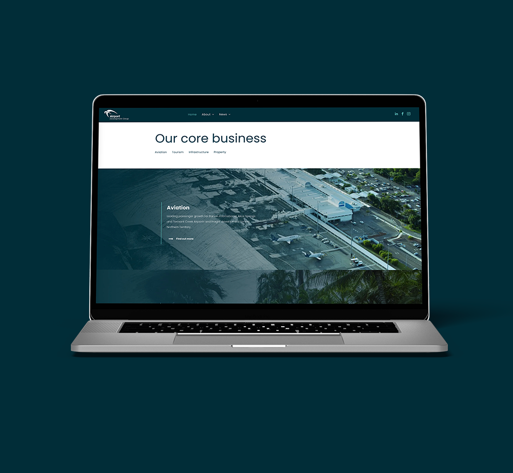 A laptop computer is open to a website on a dark blue background.