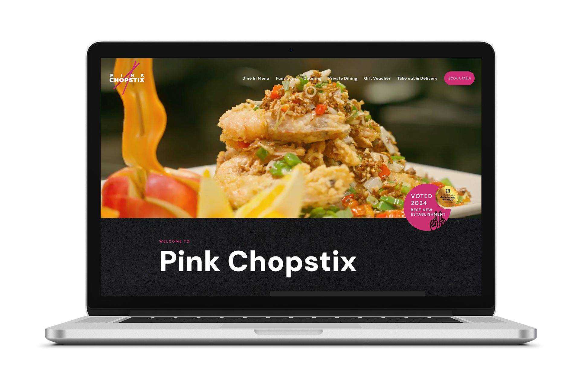 A laptop with a picture of a plate of food on the screen.