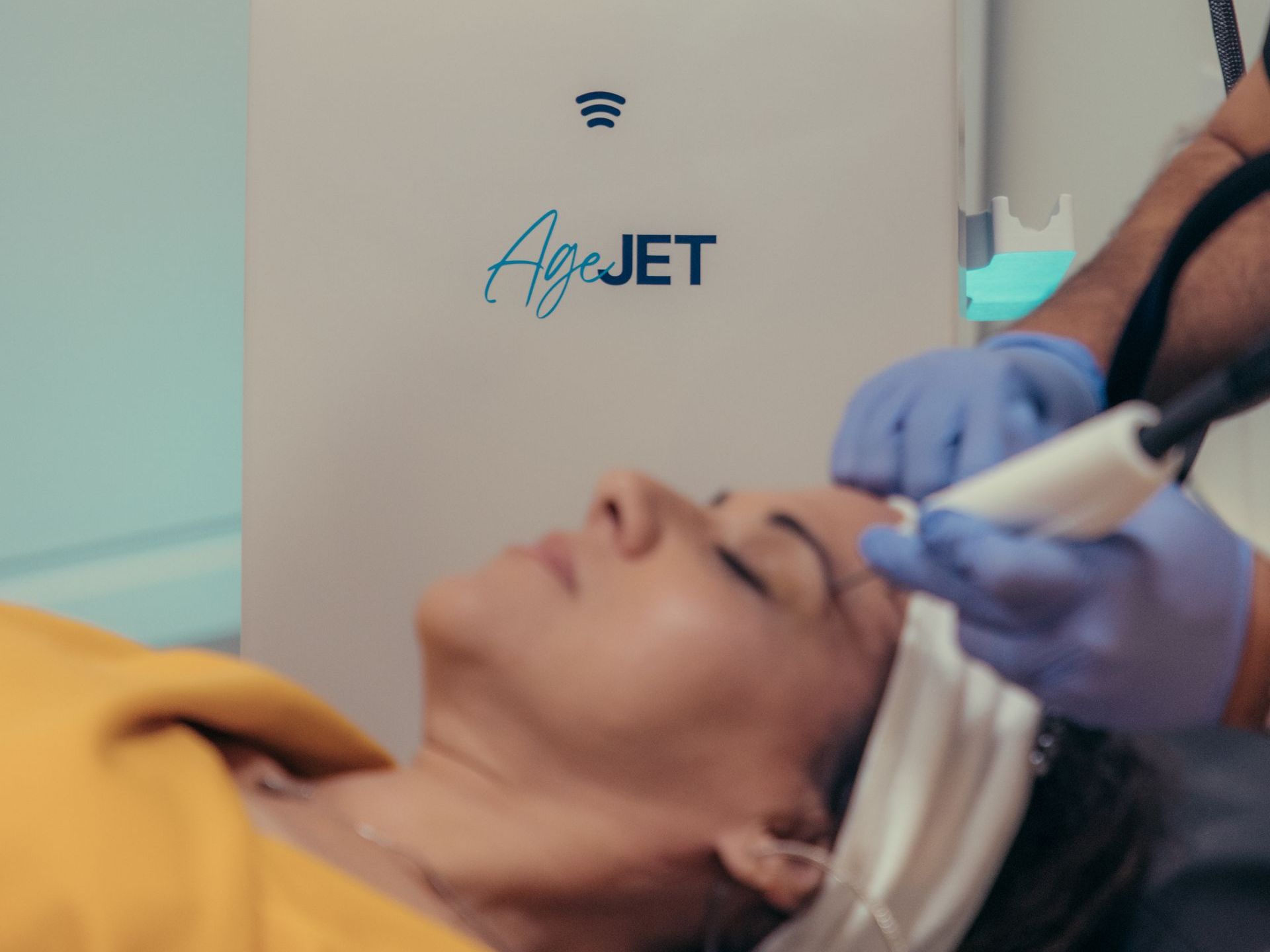 a woman is laying in front of a machine that says airjet on it