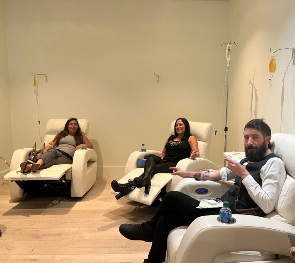 a group of people are sitting in recliner chairs in a room .