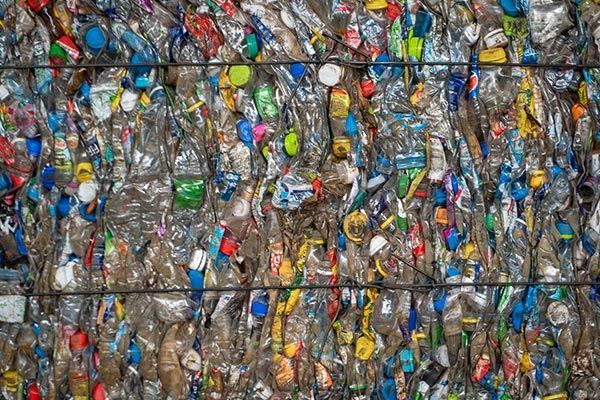 A bunch of plastic bottles are stacked on top of each other.