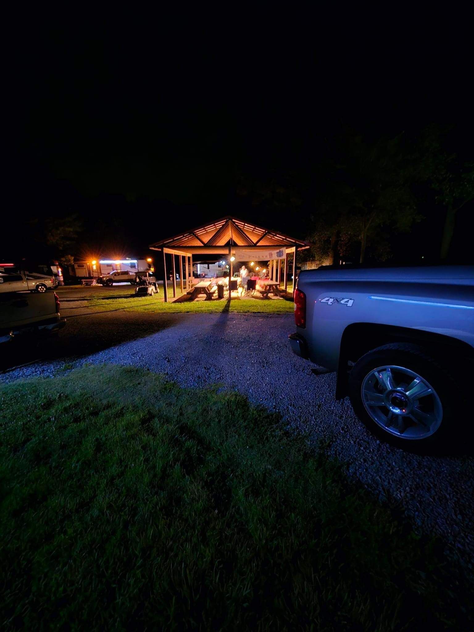 A man is standing on top of a hill at sunset.