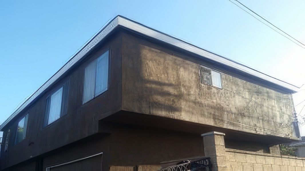 A large building with a lot of windows and a blue sky in the background.