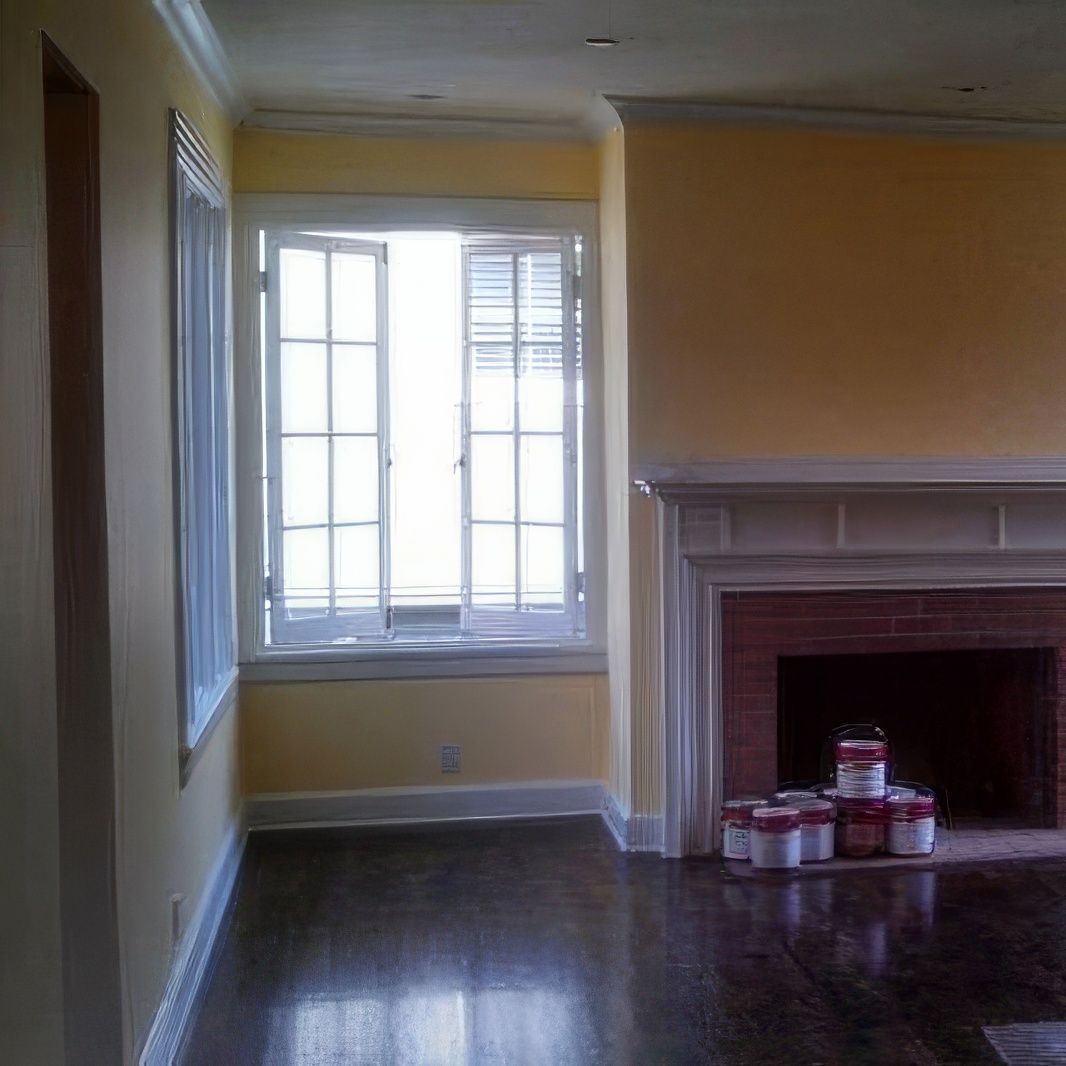 A living room with yellow walls and a fireplace