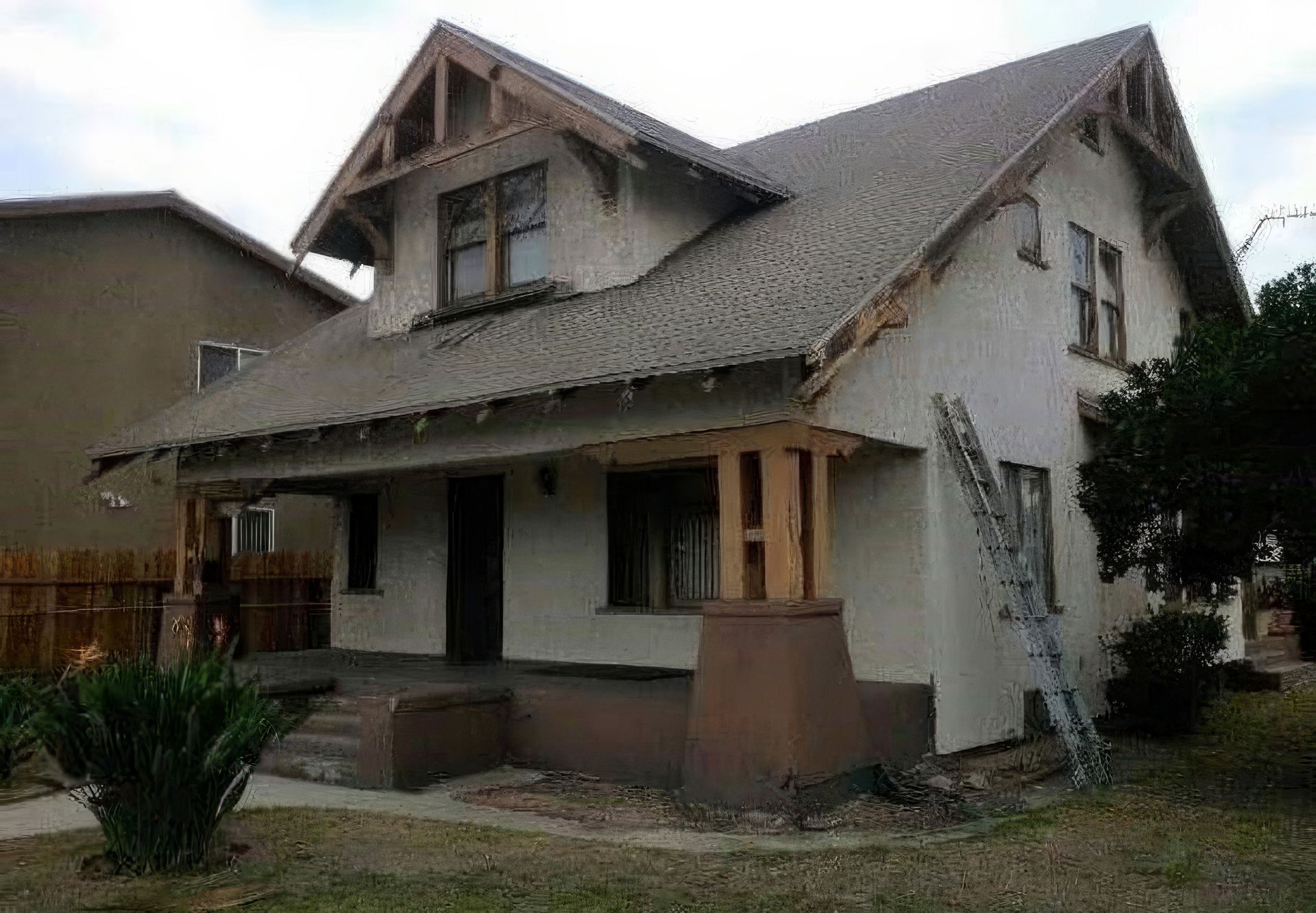 A white house with a brown roof and a ladder in front of it.