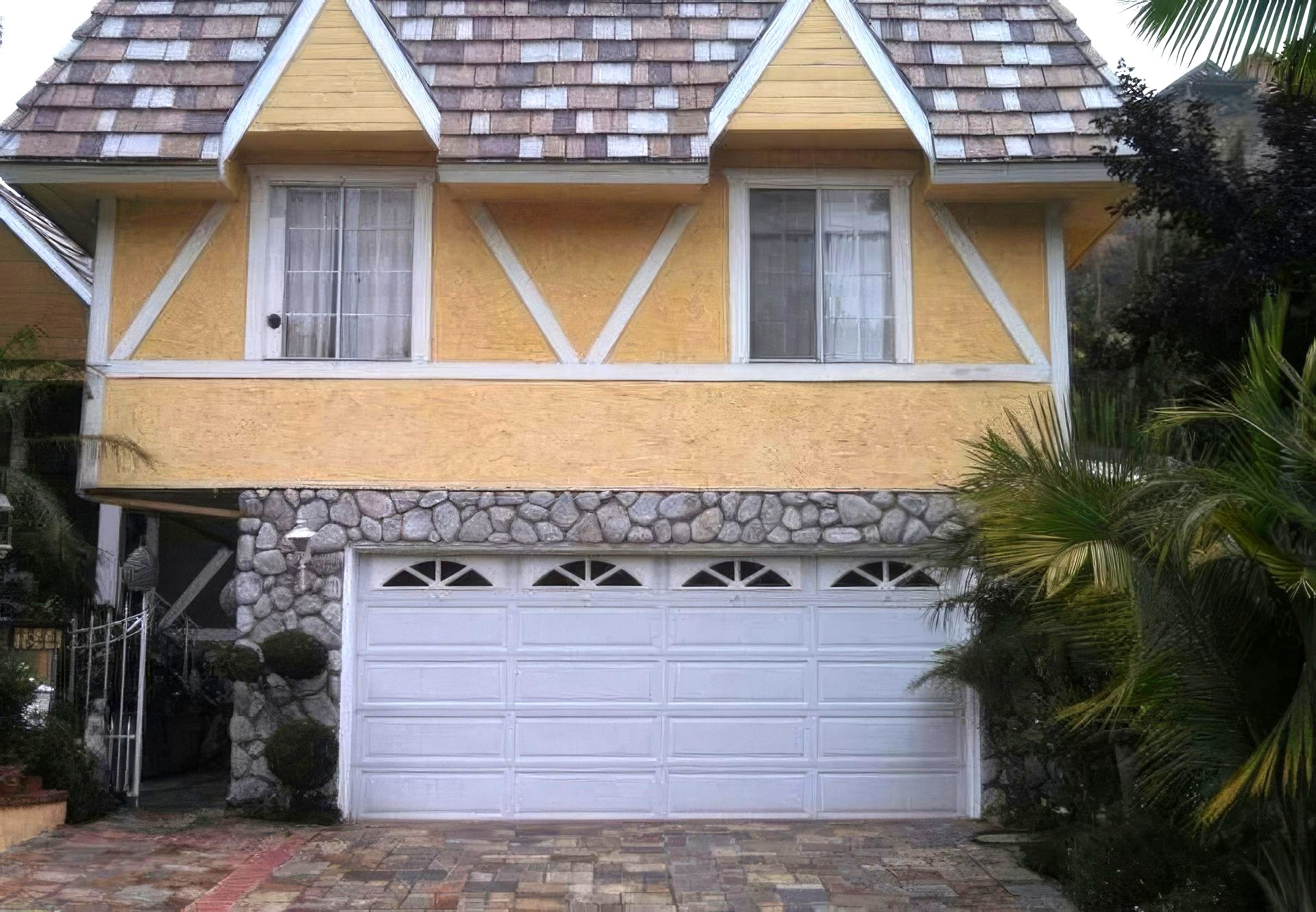 A yellow house with a white garage door