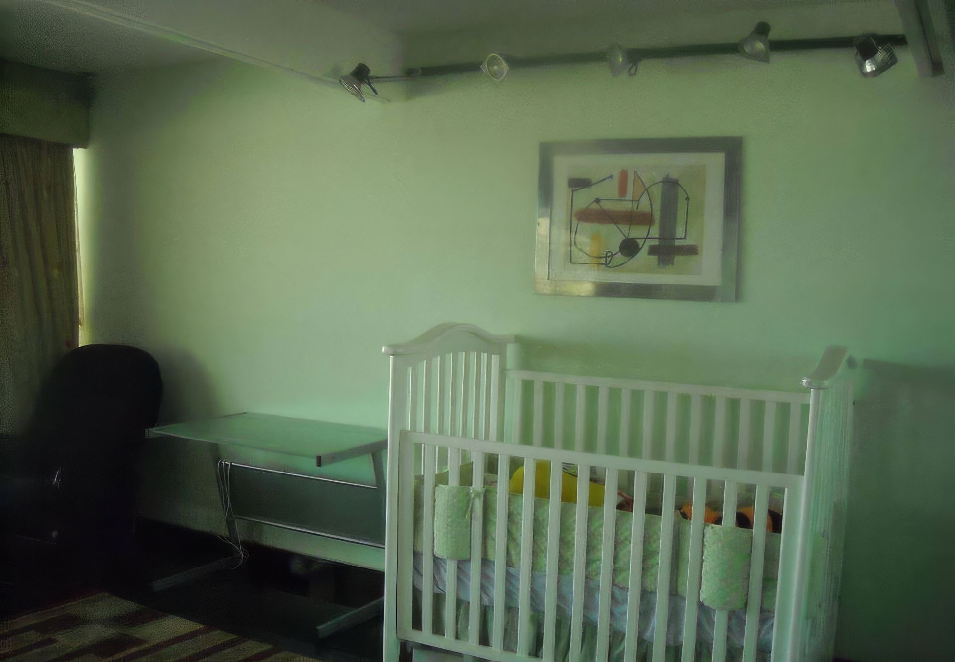 There is a crib in the middle of the room.