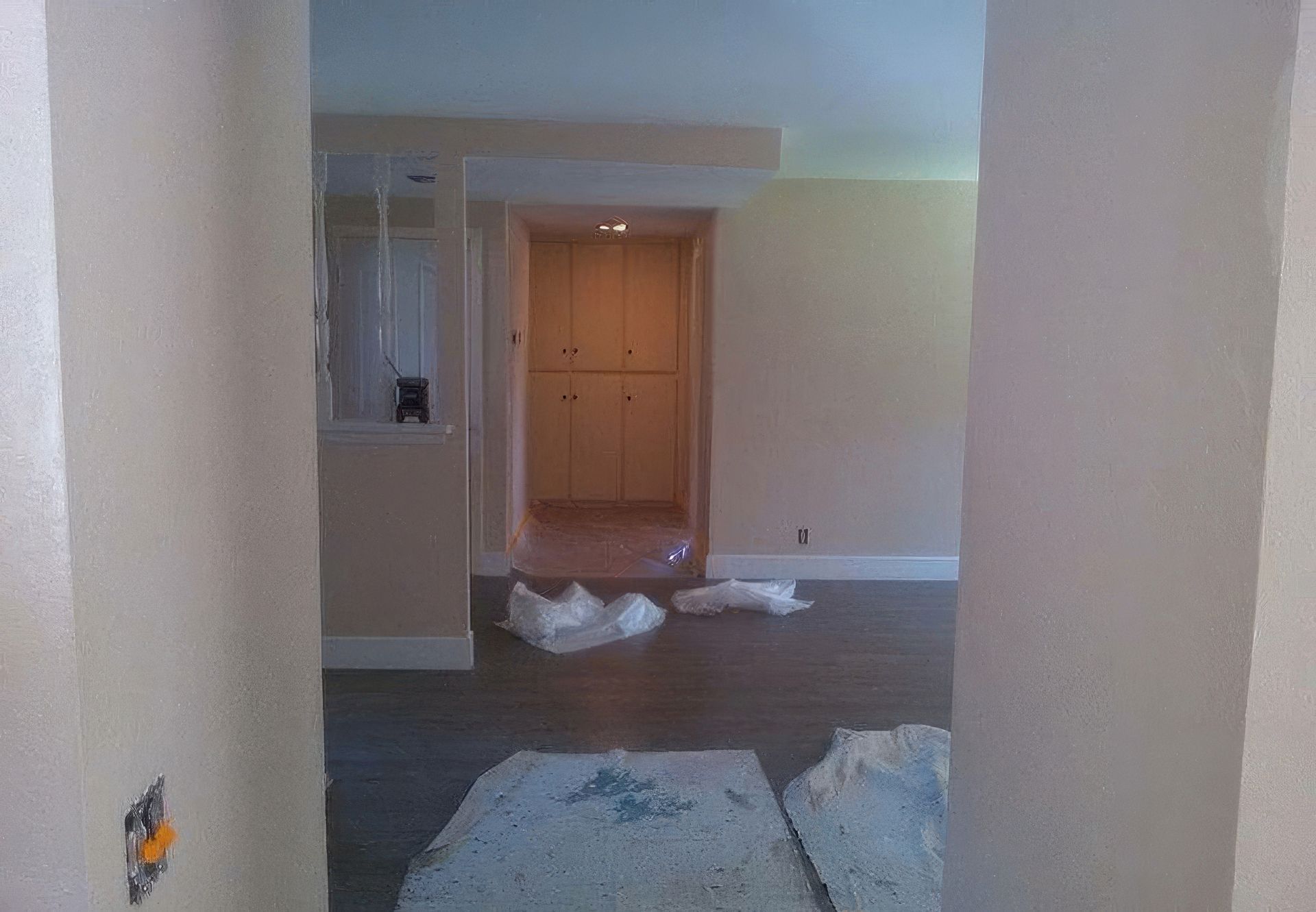 An empty room with a doorway leading to a hallway.