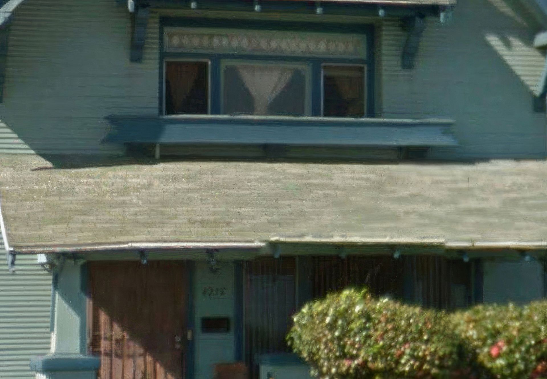 A house with a balcony on the top of it