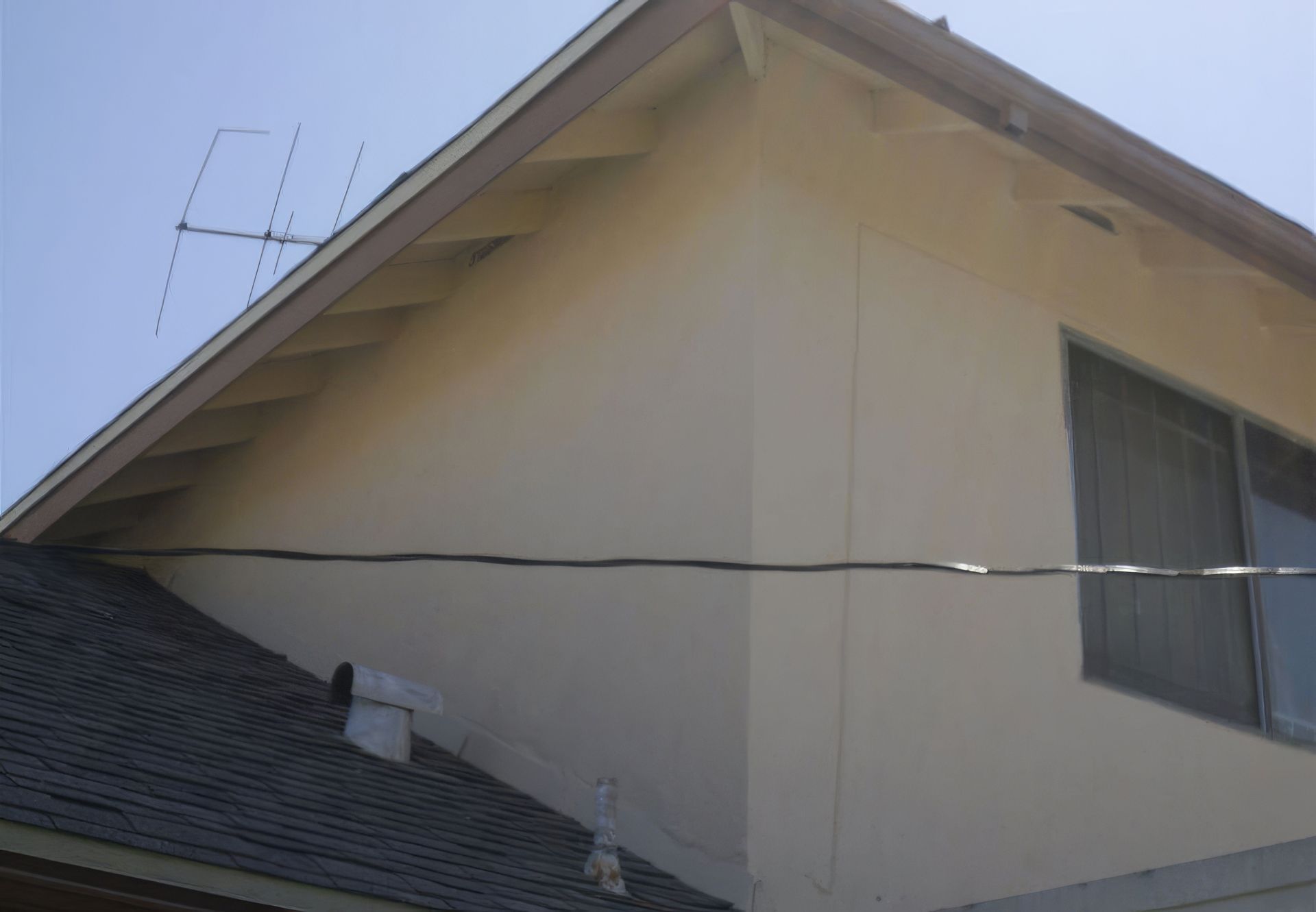 A house with a roof that has a antenna on it