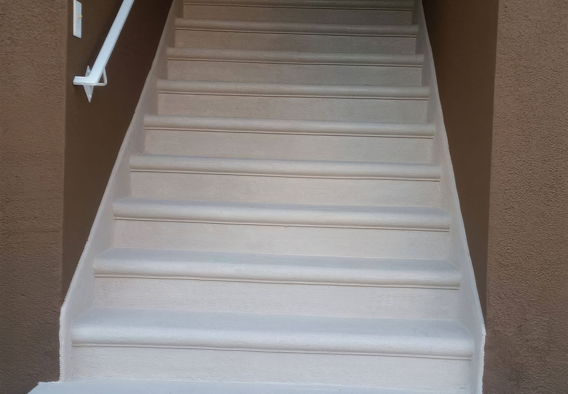 A set of stairs leading up to a brown wall