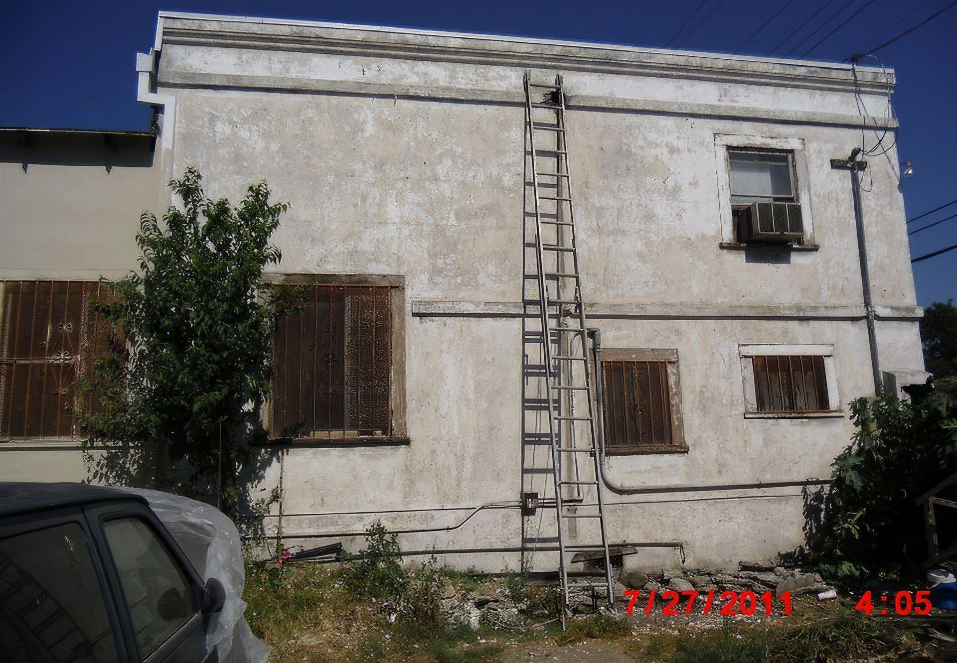 A white building with a ladder on the side of it