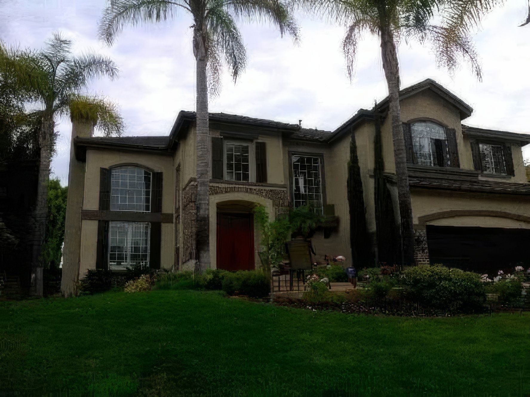 A large house with palm trees in front of it