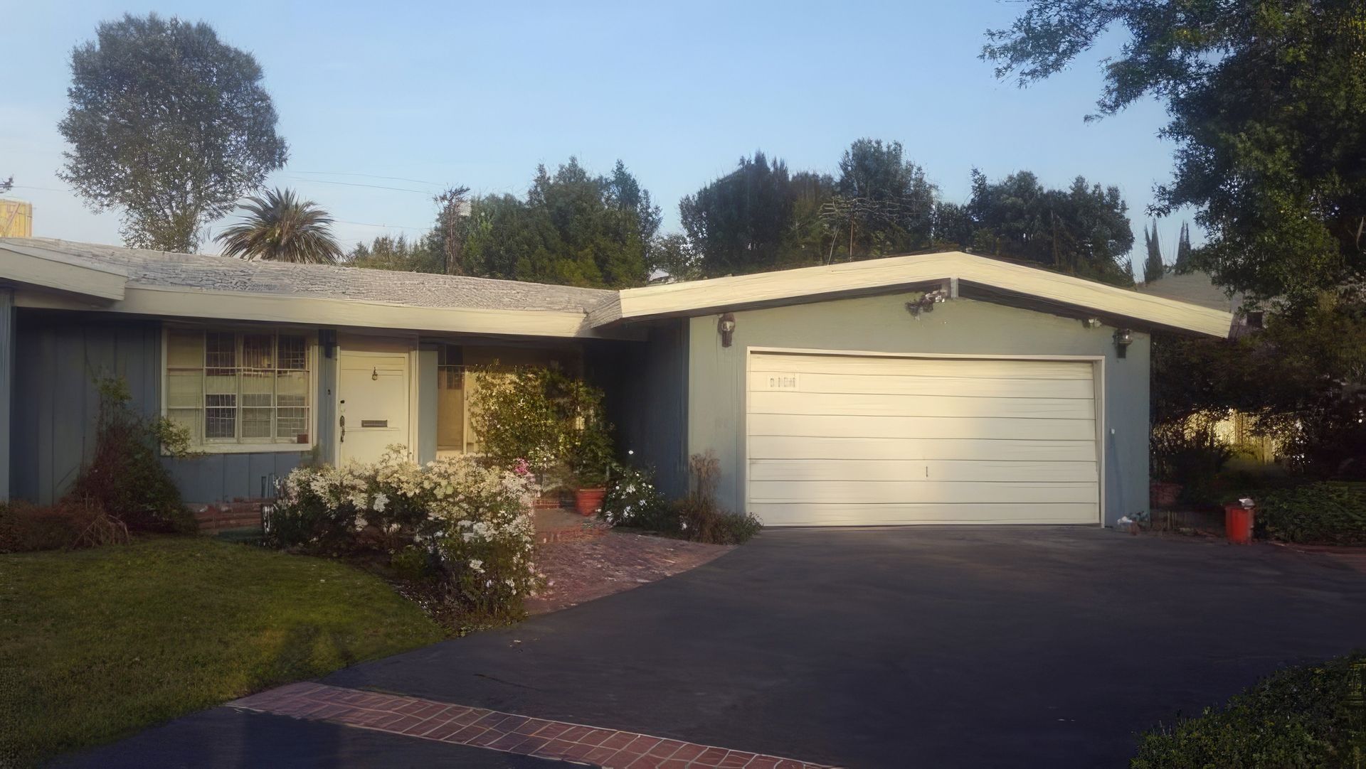 A gray house with a white garage door
