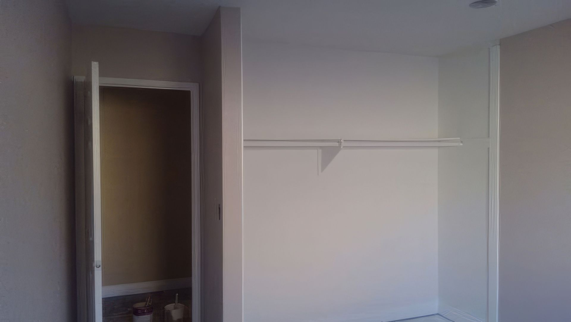 A closet with a door open and a shelf.