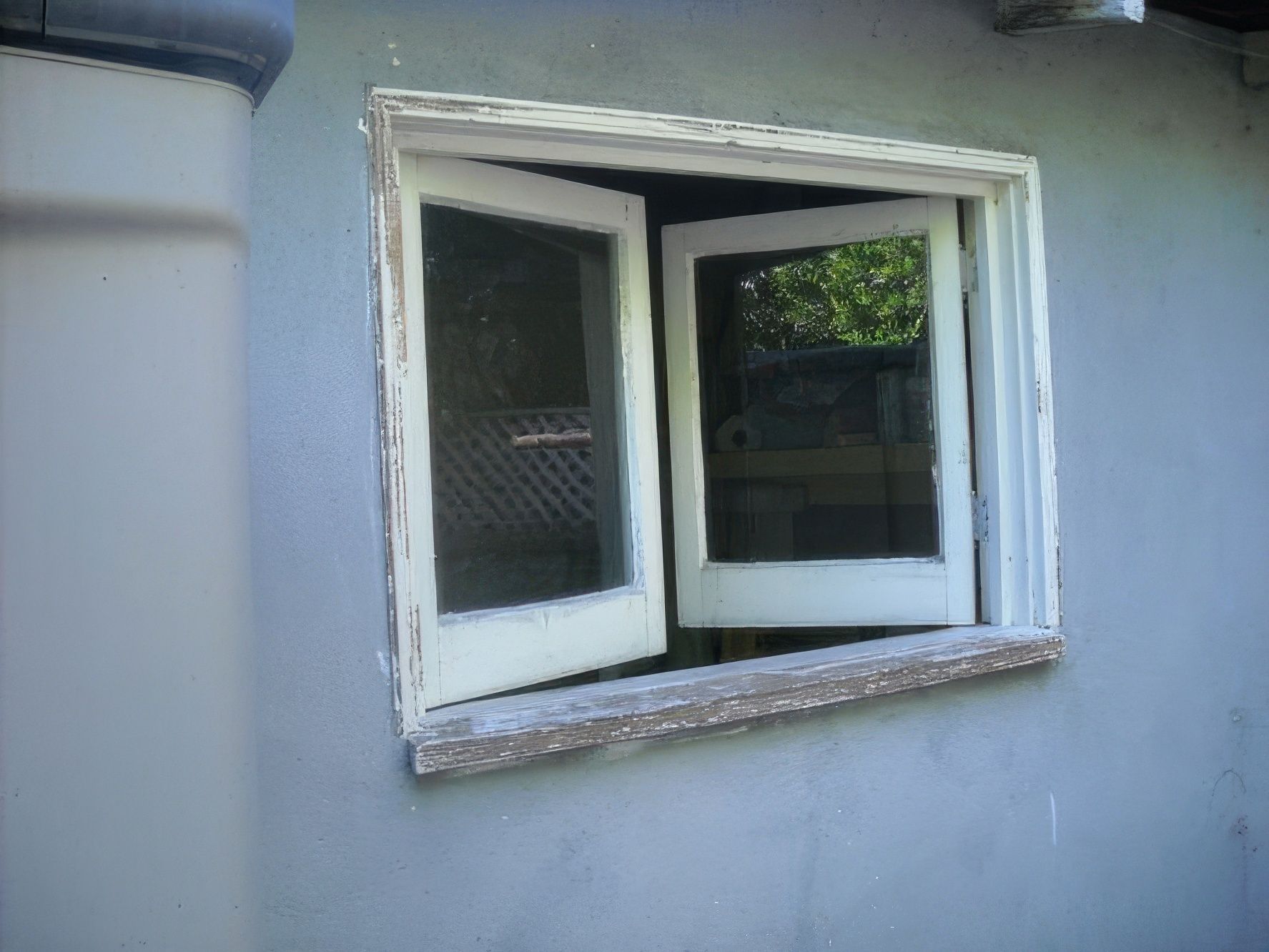 A window that is open on a gray wall