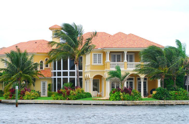 Waterfront mansion with palm trees - Naples, FL - Naples Premier Home Watch, LLC