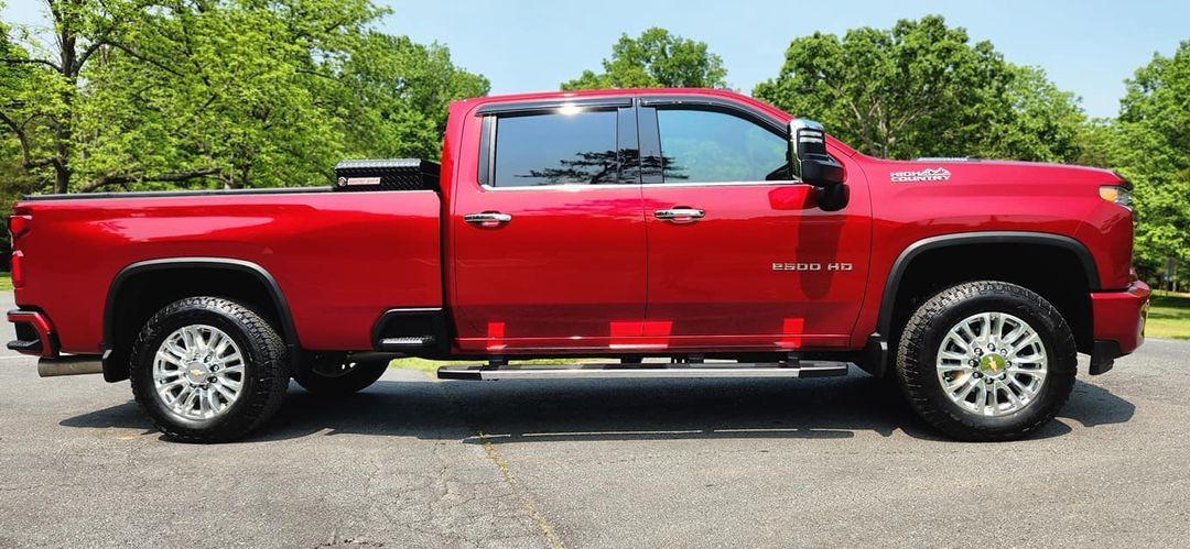 A red truck is parked on the side of the road.