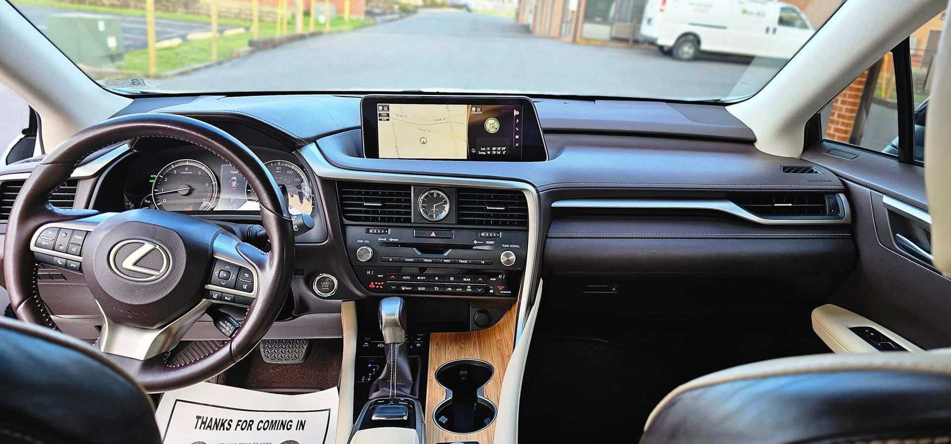 The interior of a lexus car with a steering wheel and dashboard.