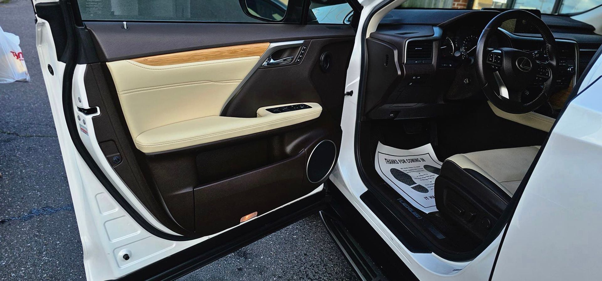 The inside of a white car with the door open.