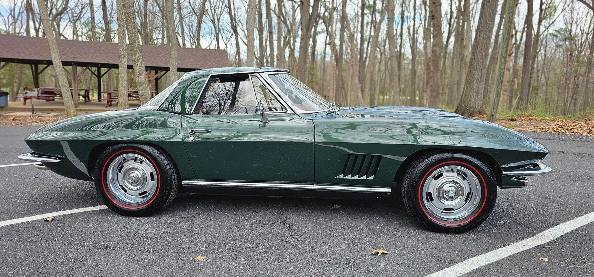 A green corvette is parked in a parking lot.
