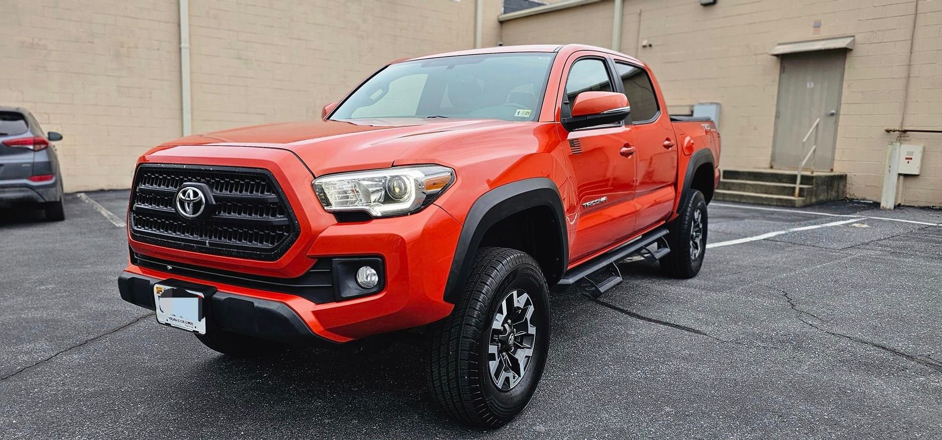 A red truck is parked on the side of the road.