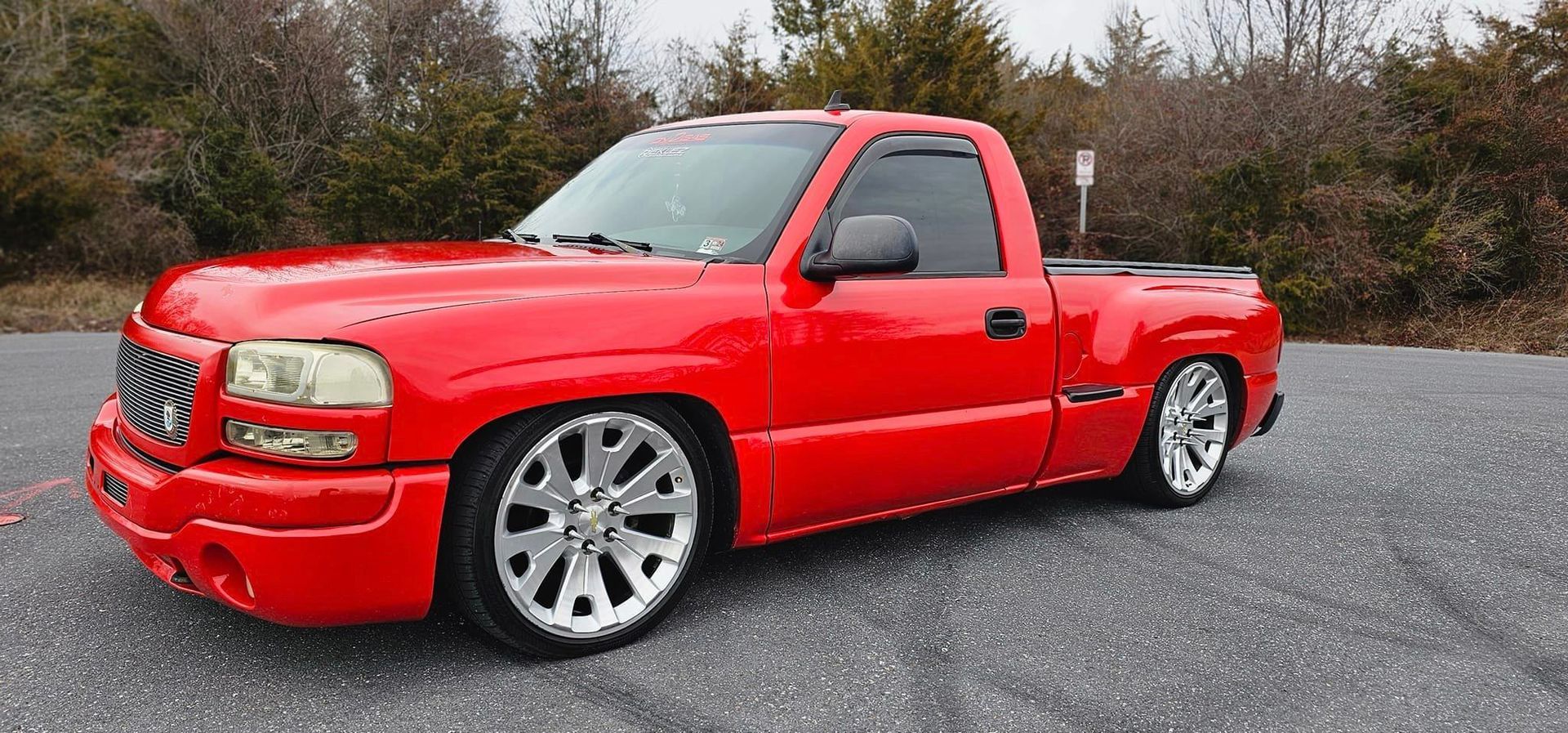 A red truck is parked on the side of the road.