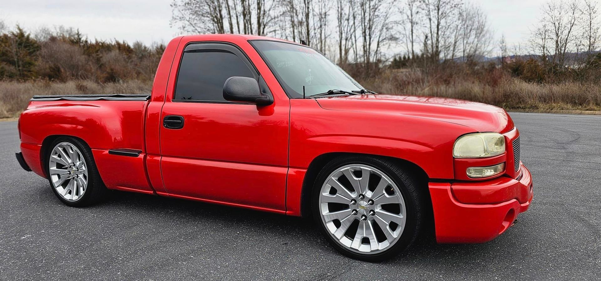 A red truck is parked on the side of the road.
