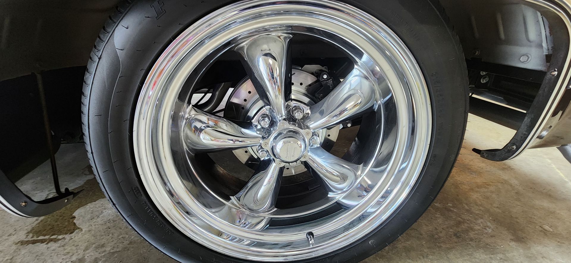A close up of a car wheel with a tire on it.