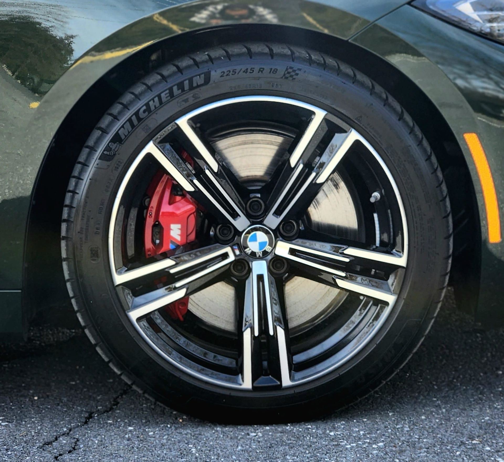A close up of a car wheel with a michelin tire on it