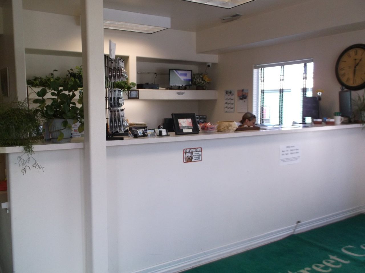 A woman sits at a counter – Springfield, OR - 42nd St Mini Storage
