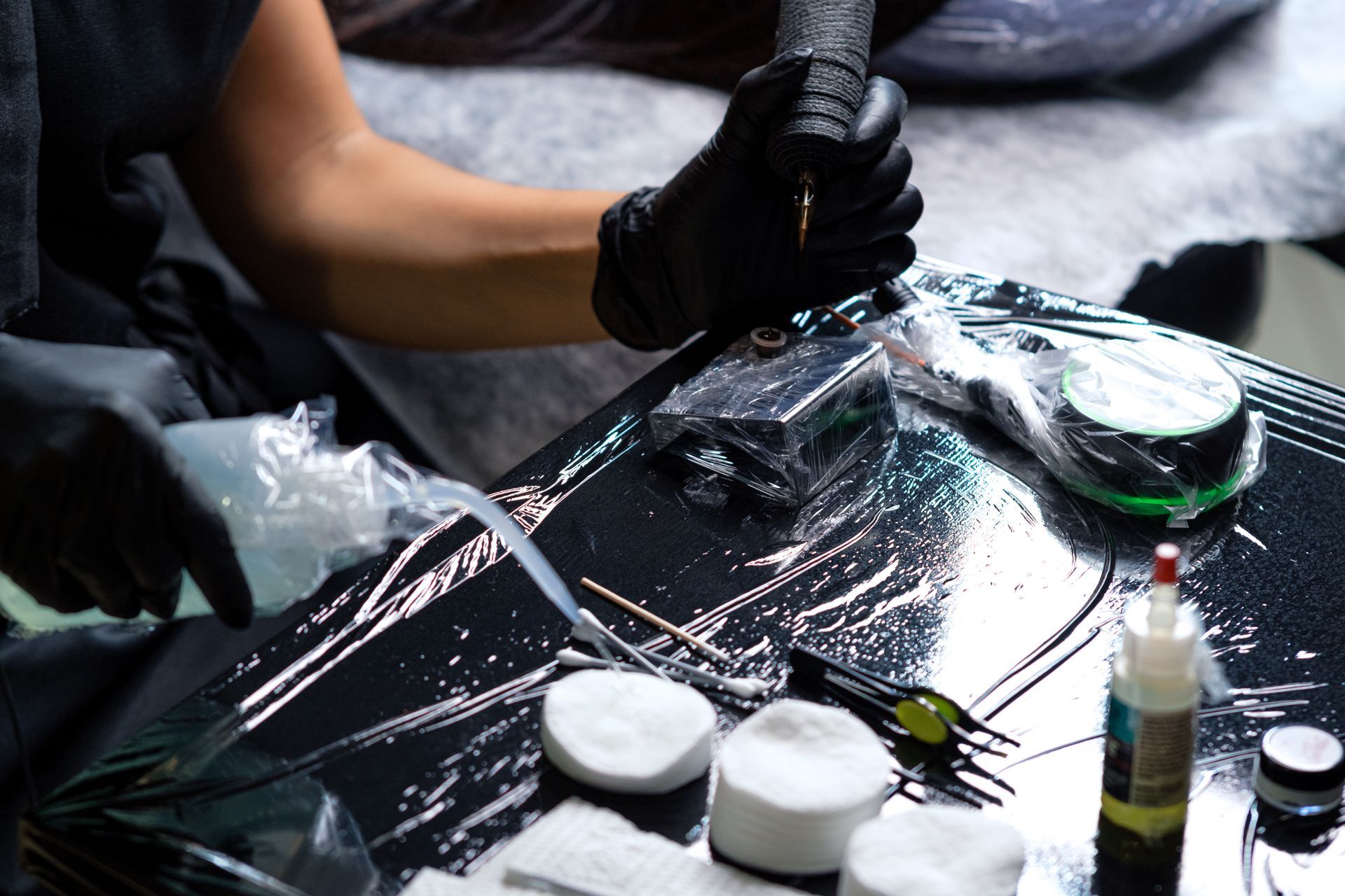 A person is getting a tattoo on a table.