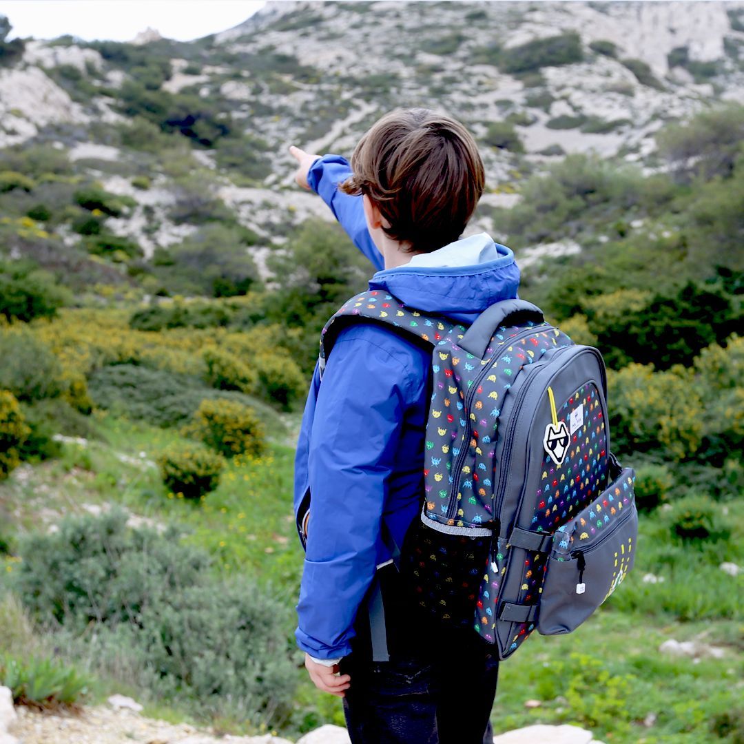 Enfant portant un sac à dos Pol Fox dans un décor nature