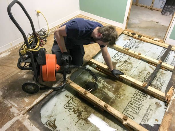 Specialist using professional machinery for floor water damage.