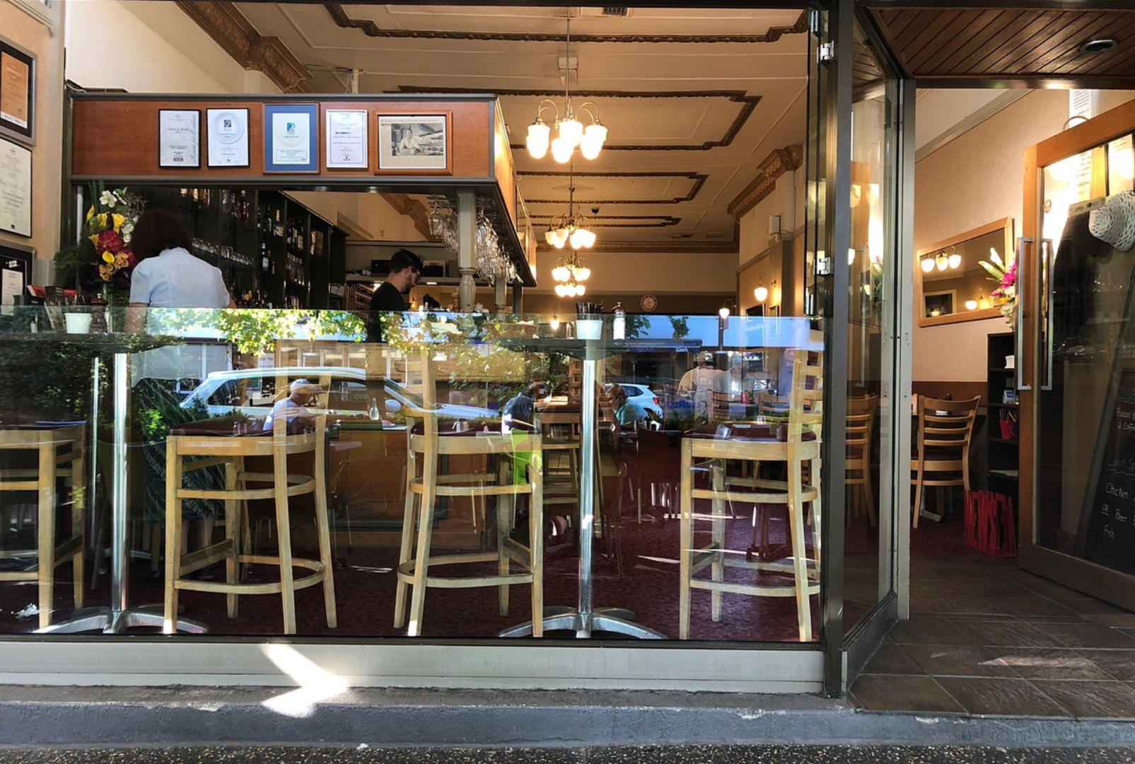 a restaurant with people sitting at tables and chairs