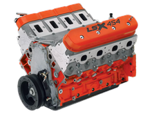 A close up of a lsx 454 engine on a white background