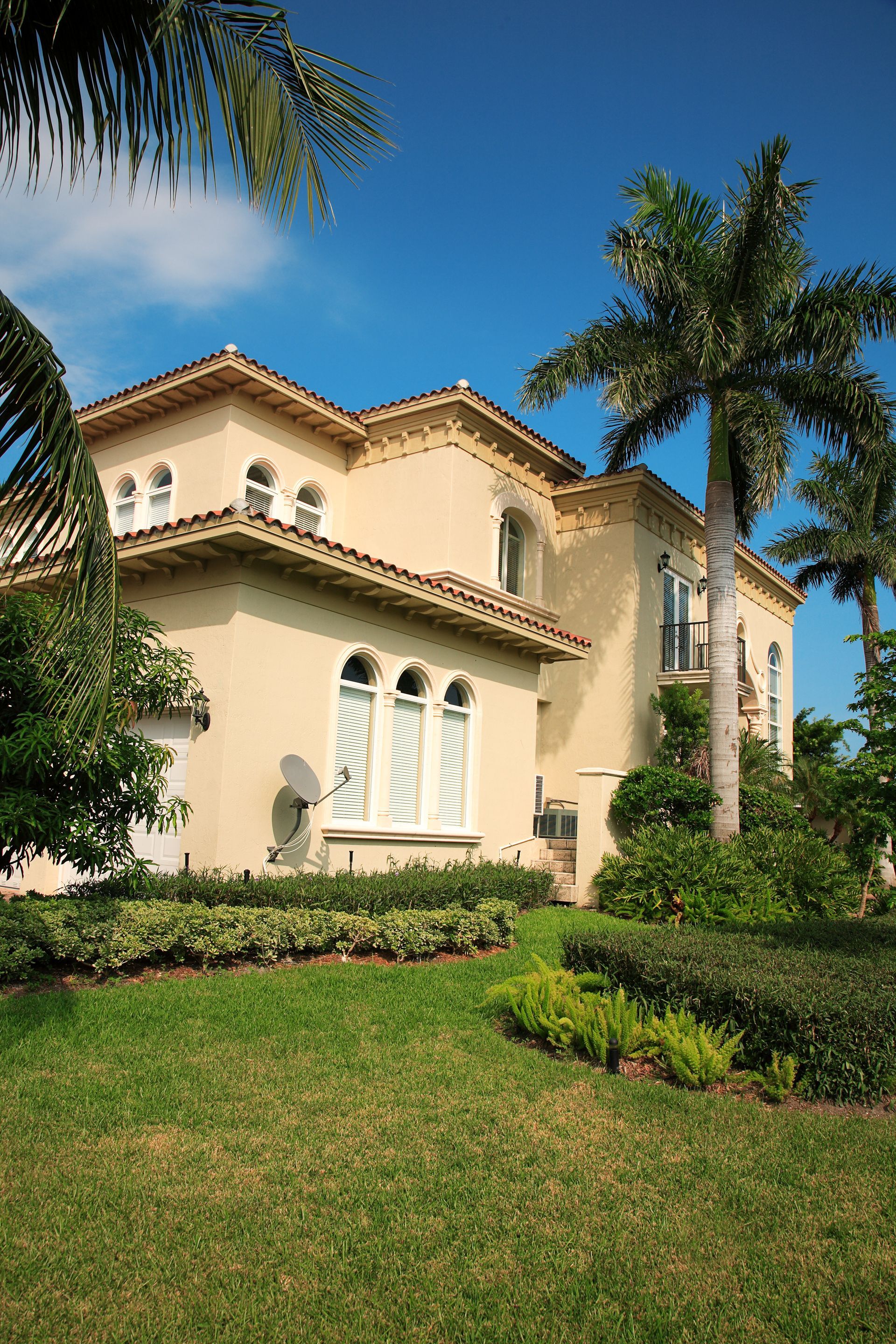 A large house with a palm tree in front of it