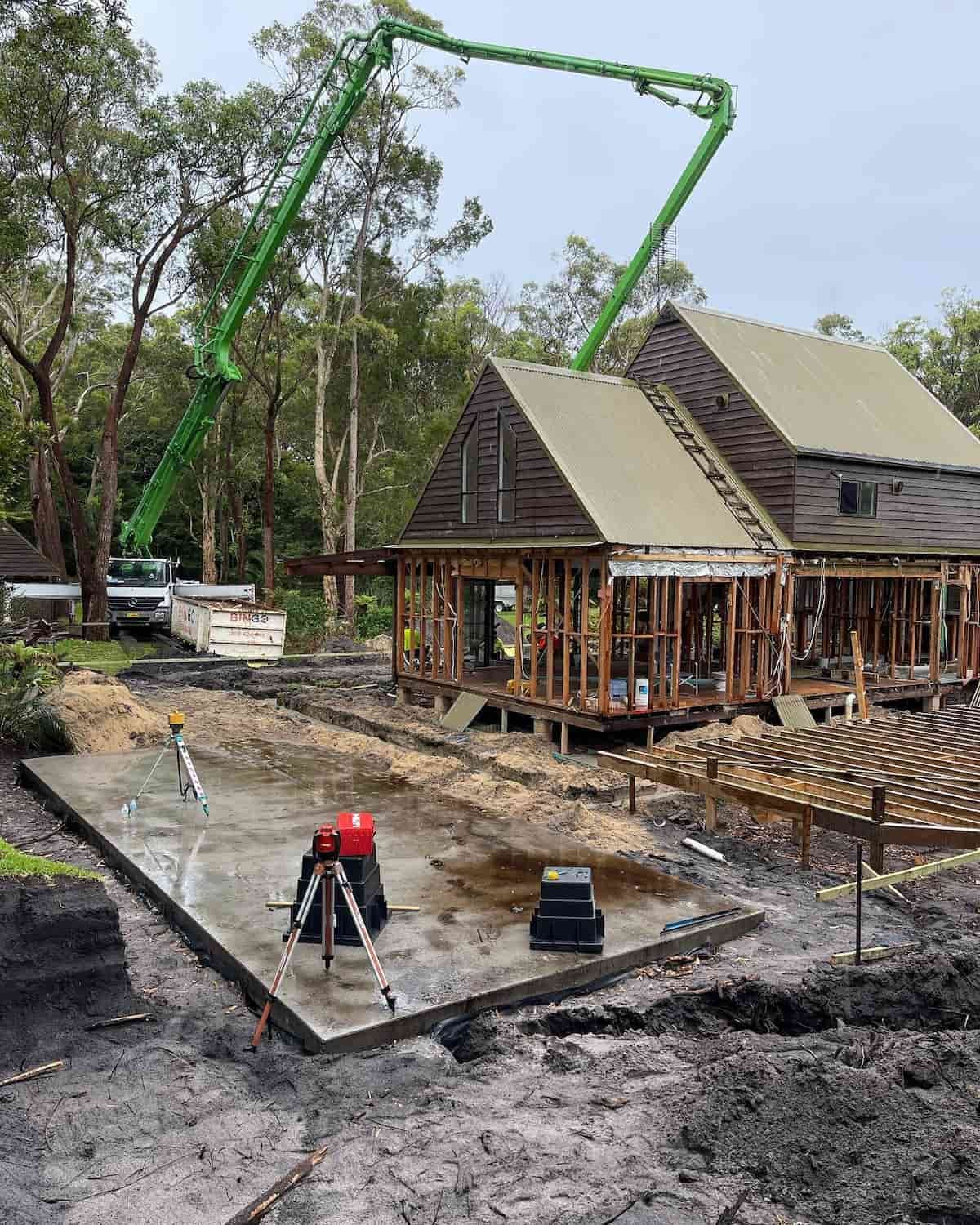 A House Is Being Built With A Green Concrete Pump — Tuncote Concrete Constructions in Anna Bay, NSW