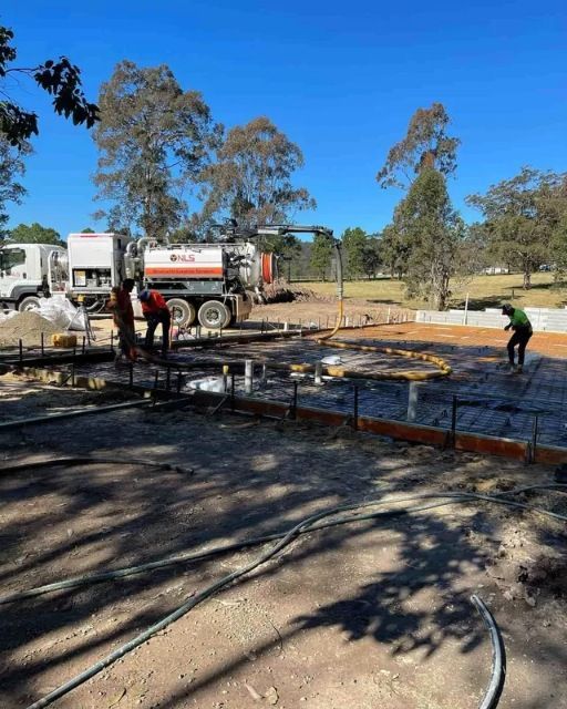 A Group Of Construction Workers Are Working On A Concrete Base — Tuncote Concrete Constructions in Medowie, NSW