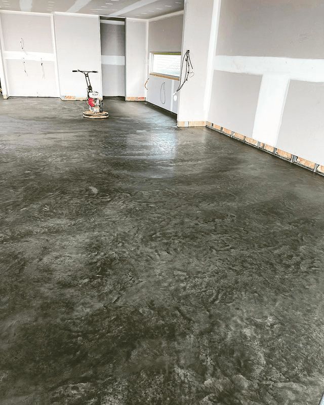 A Concrete Floor Is Being Leveled In A Room — Tuncote Concrete Constructions in Anna Bay, NSW