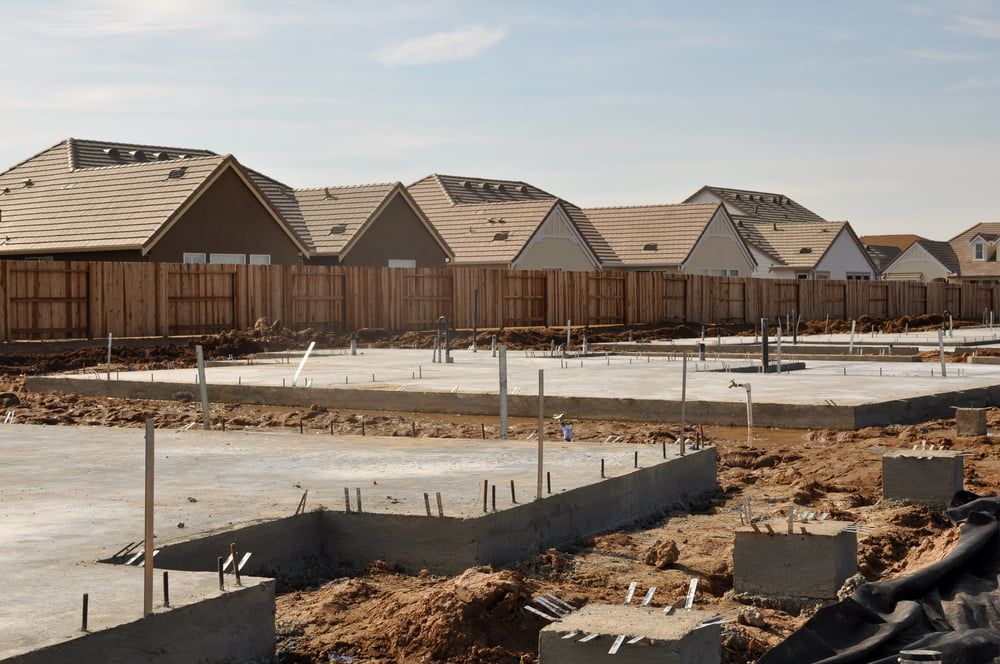 A Row Of Houses Are Being Built In A Residential Area — Tuncote Concrete Constructions in Medowie, NSW